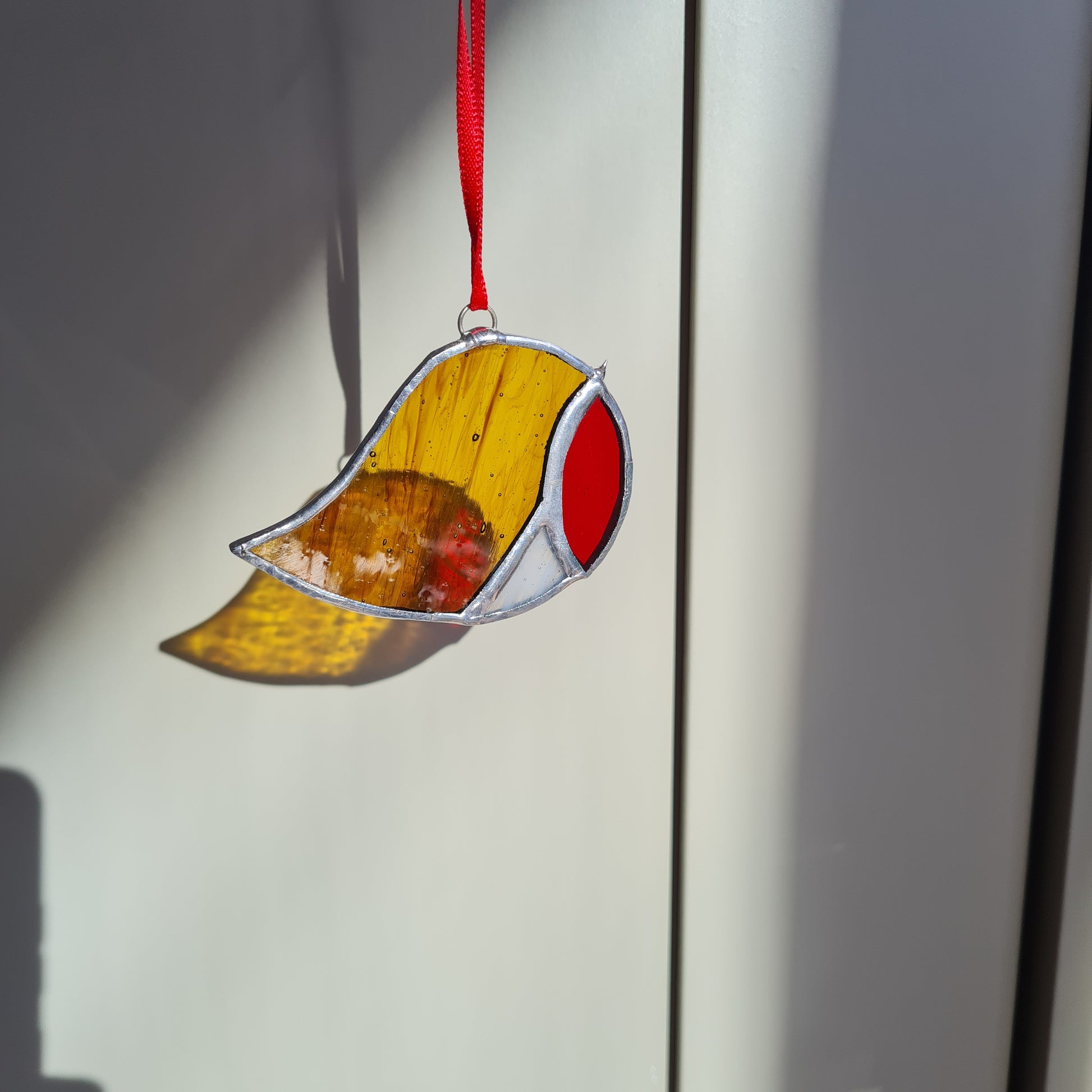 small robin stained glass suncatcher, featuring brown wispy, red and white stained glass.